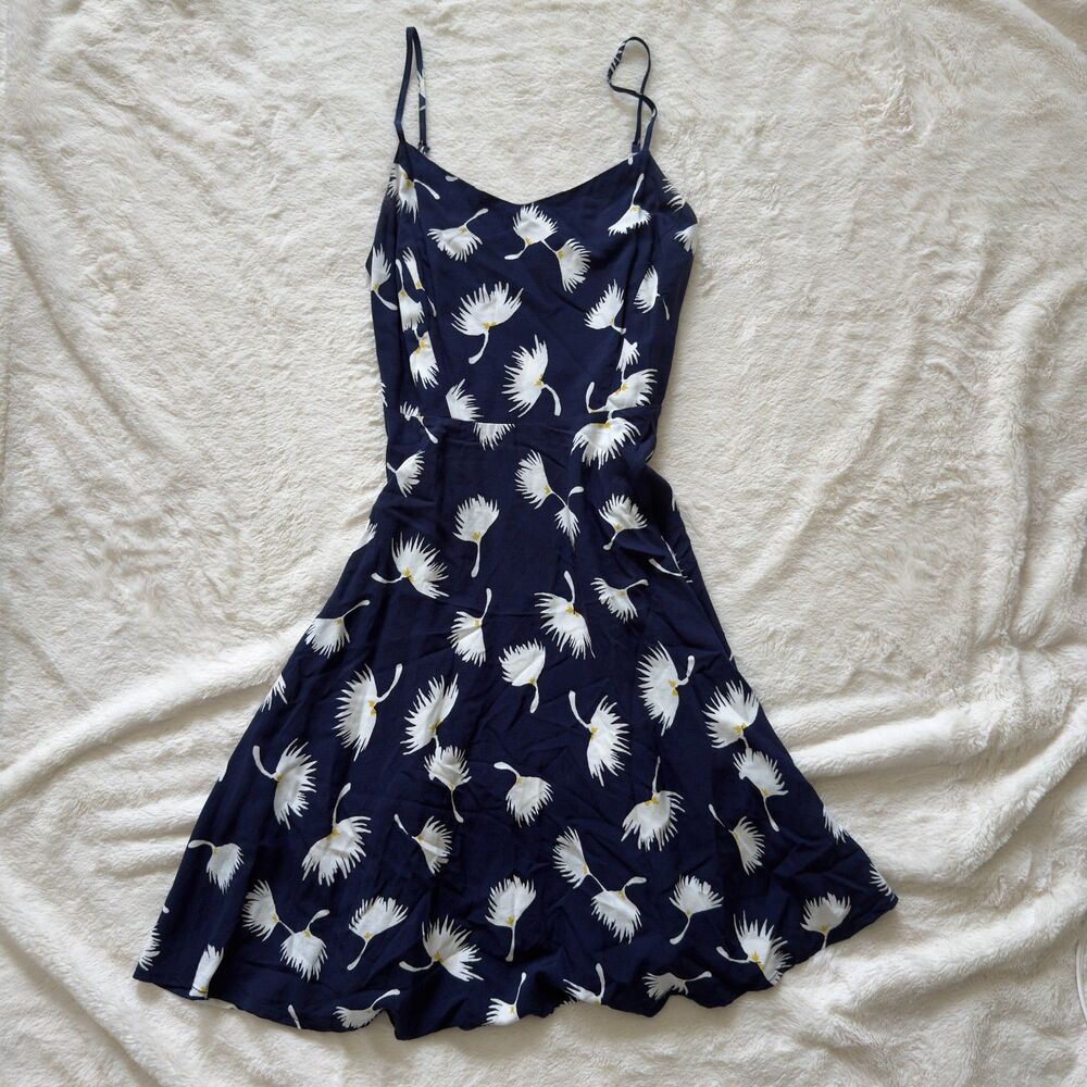 Navy blue floral midi dress with delicate spaghetti straps, fitted waist, flowy